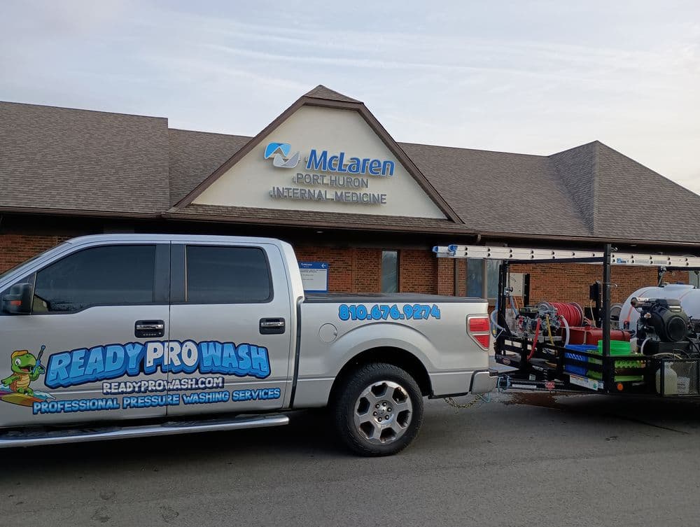 Truck with pressure washing equipment outside McLaren Port Huron Internal Medicine office.