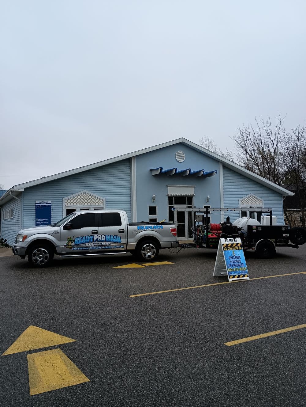 Ready Pro Wash truck parked outside a blue commercial building with signage.